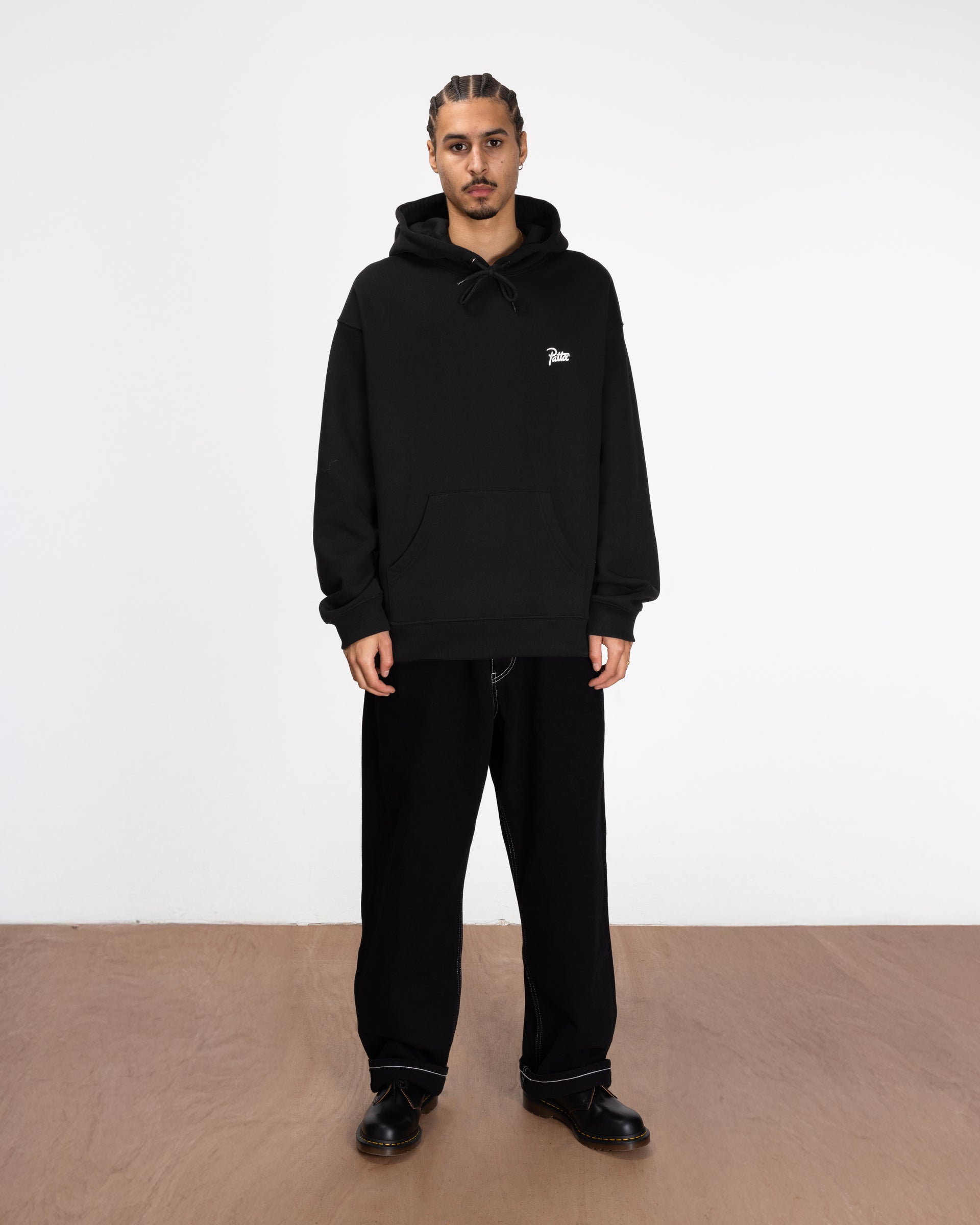 full body model shot of the bark hoodie styled with black jeans and boots