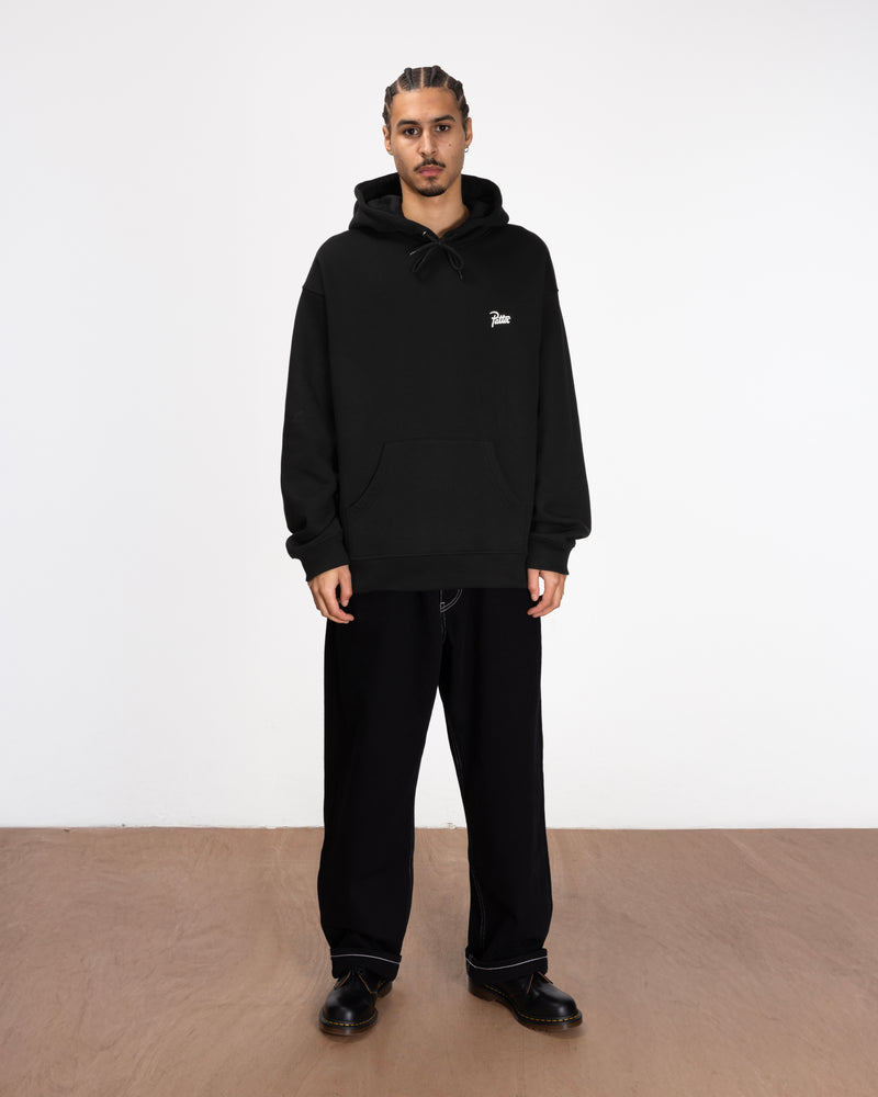 full body model shot of the bark hoodie styled with black jeans and boots