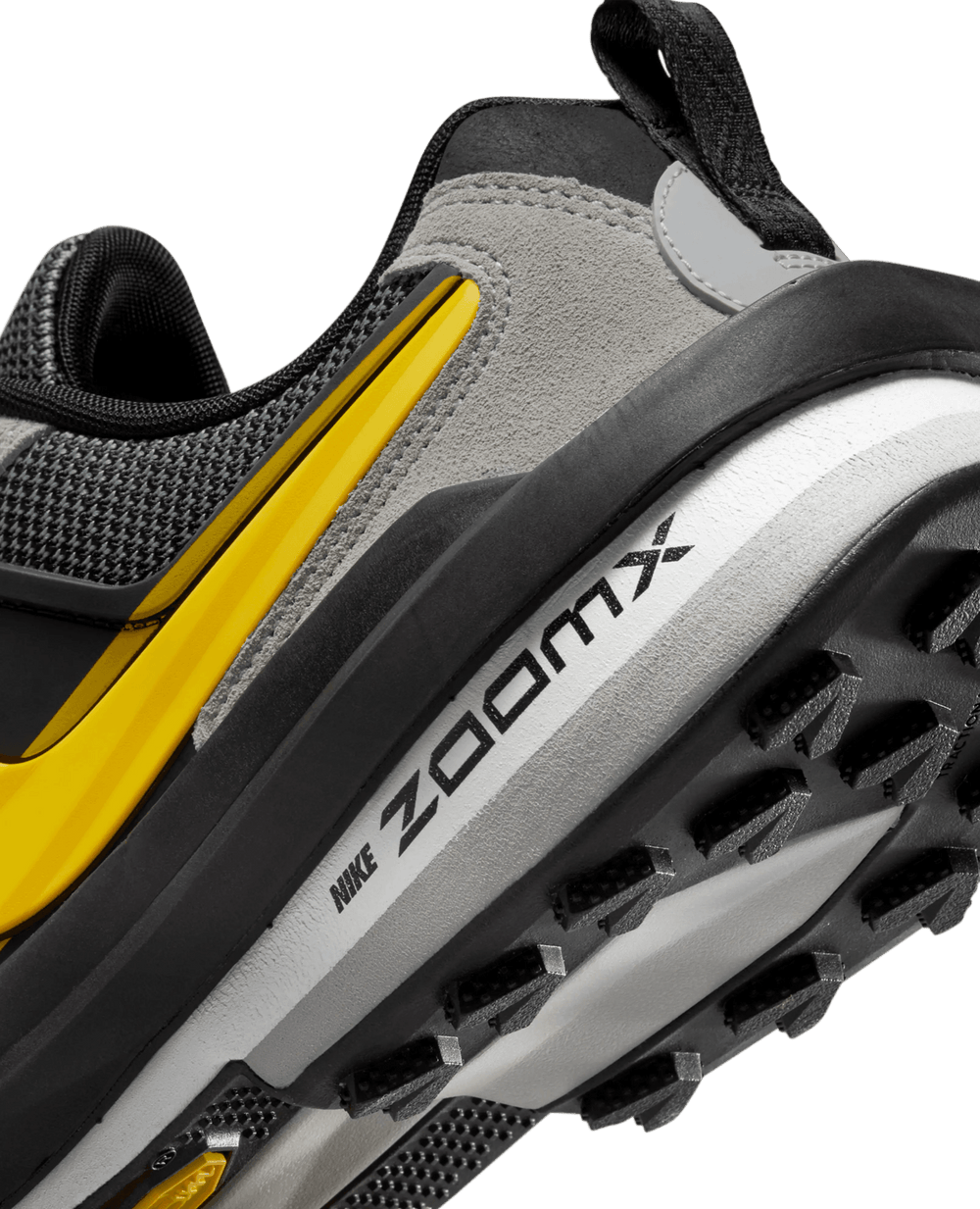 Close-up of Nike Zegamadome x Sacai sneaker heel with ZoomX midsole and yellow Swoosh detail.