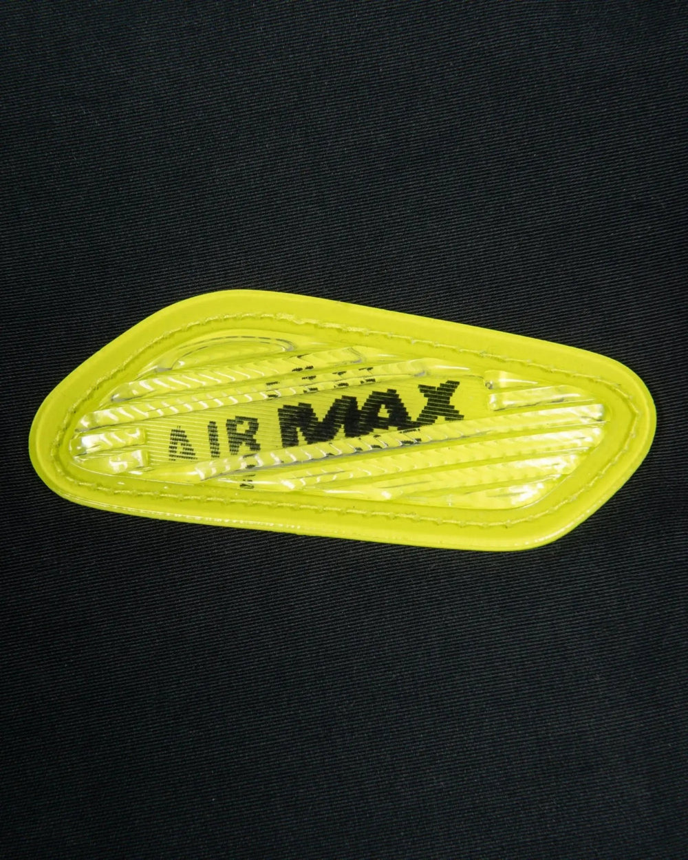 Cyber yellow lenticular Air Max badge detail on the black Patta x Nike NRG Track Jacket.