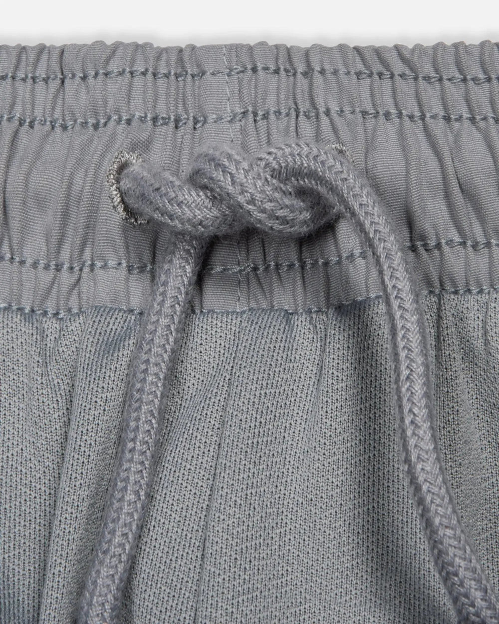 Drawstring and elastic waistband detail on the Patta x Nike NRG Track Pant in Particle Grey.